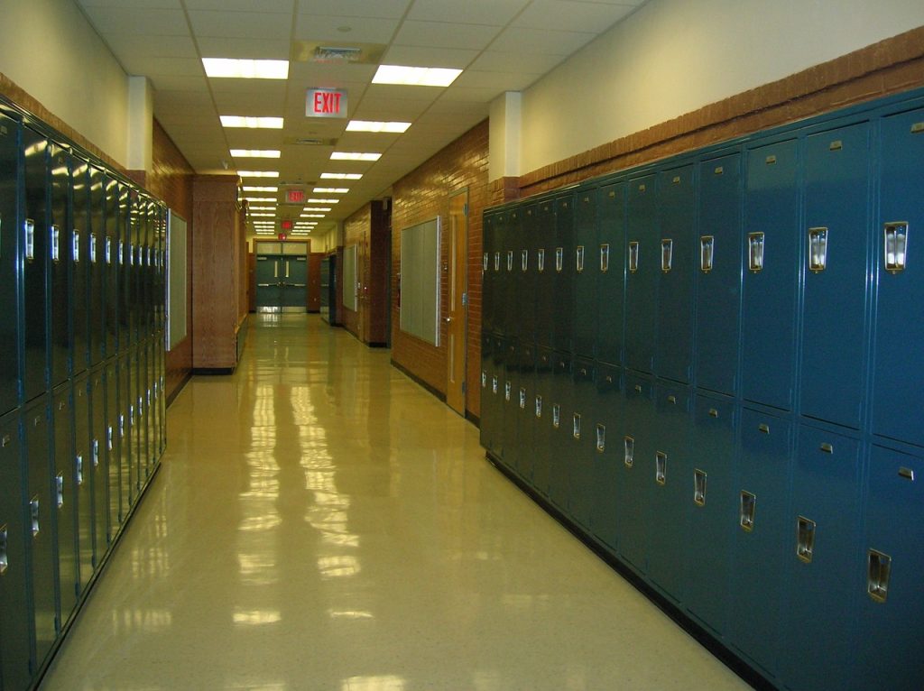 Highschool Hallway with lockers running down each site.